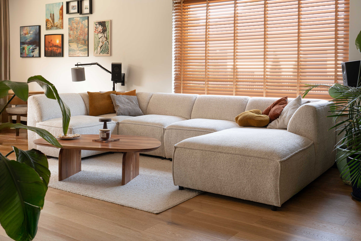 Brick modular sofa in a bright, cosy living room with yellow and orange corduroy cushions