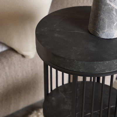 Cella Round Bedside Table with a Black Marble Effect, Modern Style – in a room setting