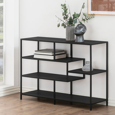 Étagère Skeleto 114 x 78 en mélamine noire près d'une fenêtre, avec des brindilles dans un vase, une sculpture et des livres – étagère noire pour le salon